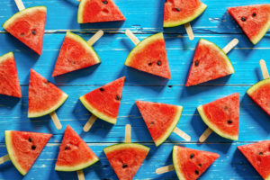Watermelon,Slice,Popsicles,On,A,Blue,Rustic,Wood,Background