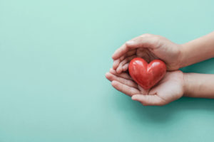 Hands,Holding,Red,Heart,,Health,Care,,Hope,,Love,,Organ,Donation,