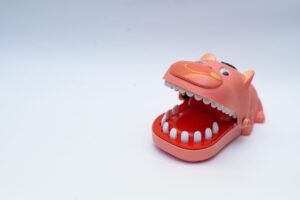 Dentist,Finger,Bite,Or,Tricky,Toy,On,Isolated,White,Background.