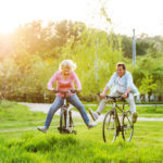 Beautiful,Senior,Couple,With,Bicycles,Outside,In,Spring,Nature.