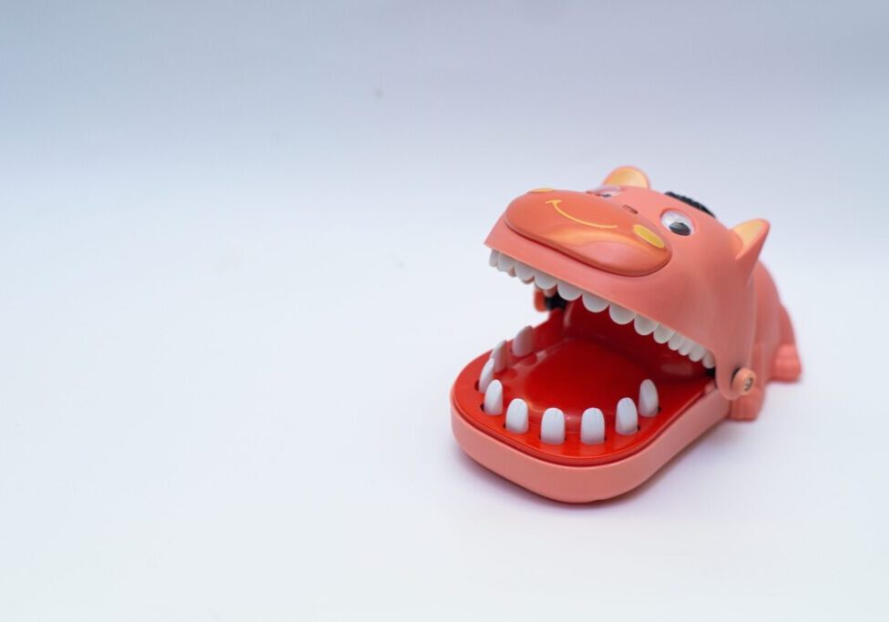 Dentist,Finger,Bite,Or,Tricky,Toy,On,Isolated,White,Background.